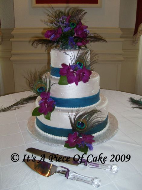 3tiered fondant covered wedding cake featuring blue bands orchids and 