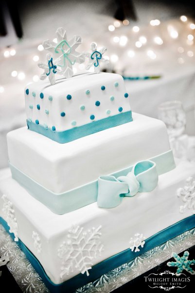 The Snowflake This is a 3 tiered square wedding cake with fondant bands and